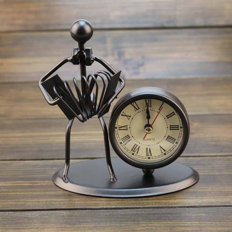 Retro small alarm clock with black metal figure base and round cream clock face