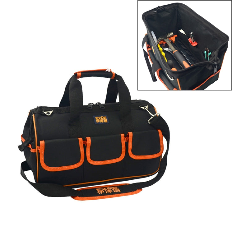 Black oxford tool tote bag with orange trim, top handles, and front organizer pockets