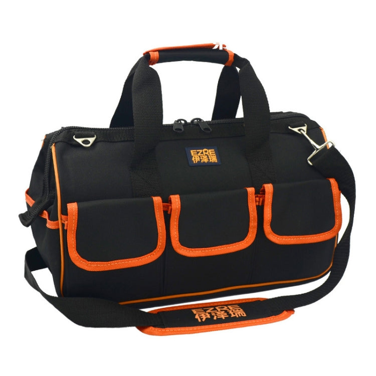 Black tool duffel with orange trim, wide opening and front utility pocket panels