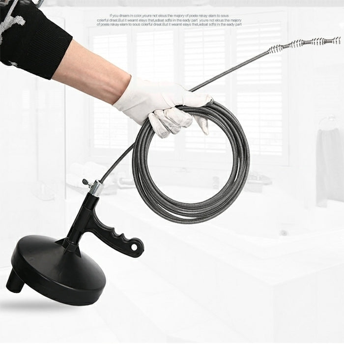 Drain cleaning tool being used with gloves, showing coiled cable and handle