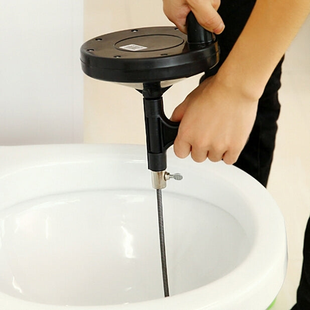 Hand operating black drain cleaning tool inserted into a bathtub drain