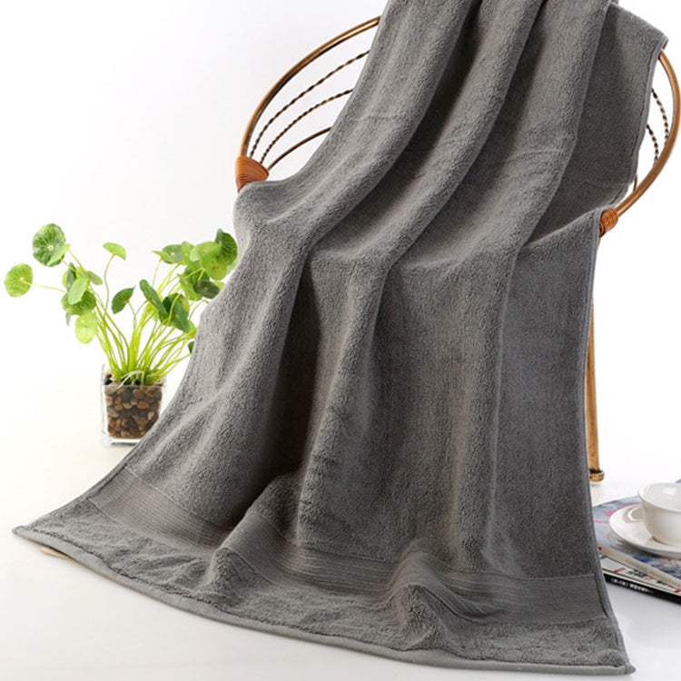Grey bath towel with folded edge and visible looped terry texture