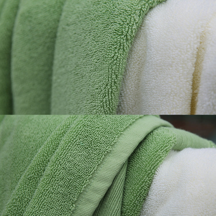 Green terry bath towel with close-up of looped pile fabric