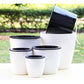 Group of white self-watering planters with black top inserts in assorted sizes