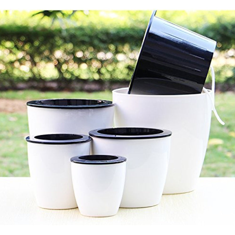 Group of white self-watering planters with black top inserts in assorted sizes