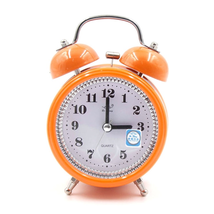 Orange metal twin bell alarm clock with analog face, quartz text, and blue night-light icon.
