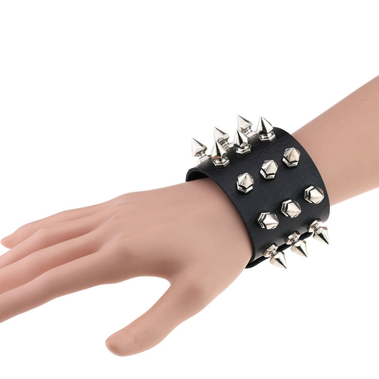 Black studded leather conical-tip spike bracelet with silver rivets on wrist