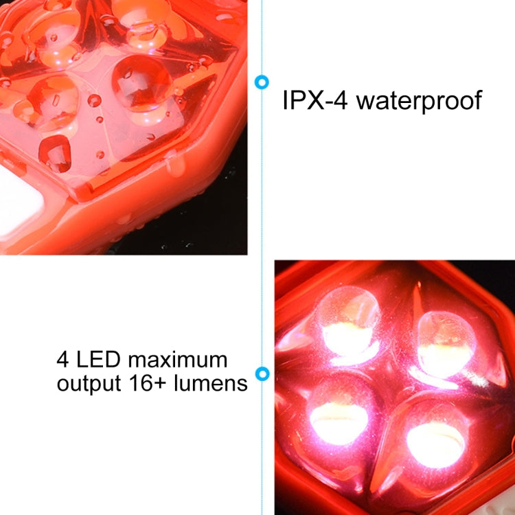 Red LED bike clip taillight close-up with four bright LEDs glowing behind clear lens.