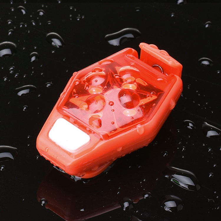 Red LED bike clip taillight with white light, shown in water droplets.