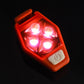 Red LED bike clip taillight, four LEDs glowing in dark lighting.
