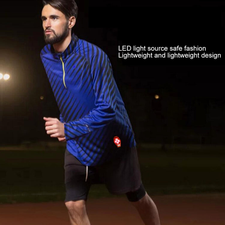 Red LED bike clip taillight attached to a runner’s clothing during night exercise.
