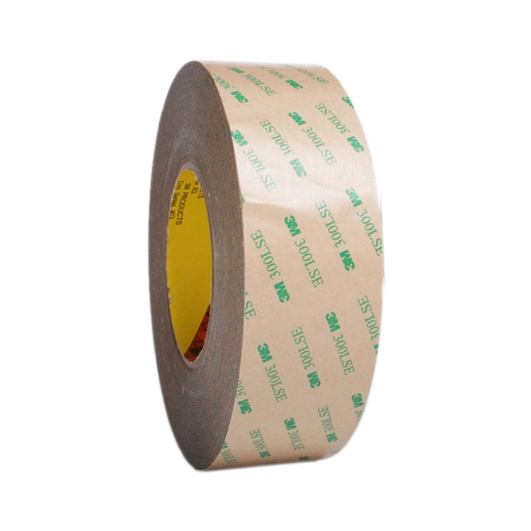 Transparent double-sided adhesive tape roll on gray backing, angled side view
