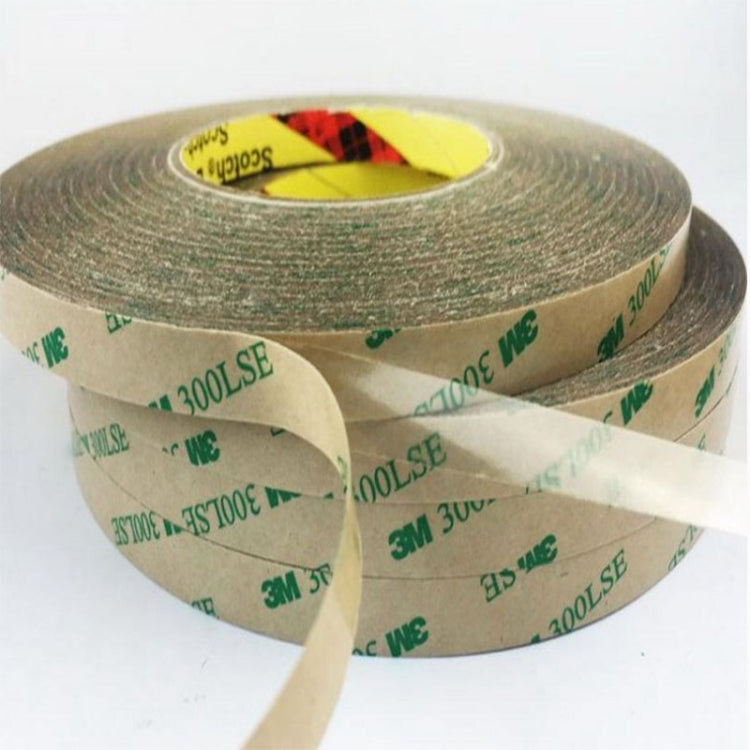Close-up of transparent double-sided adhesive tape roll with lifted tape strip