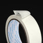 White masking tape roll edge detail, paper backing with adhesive strip