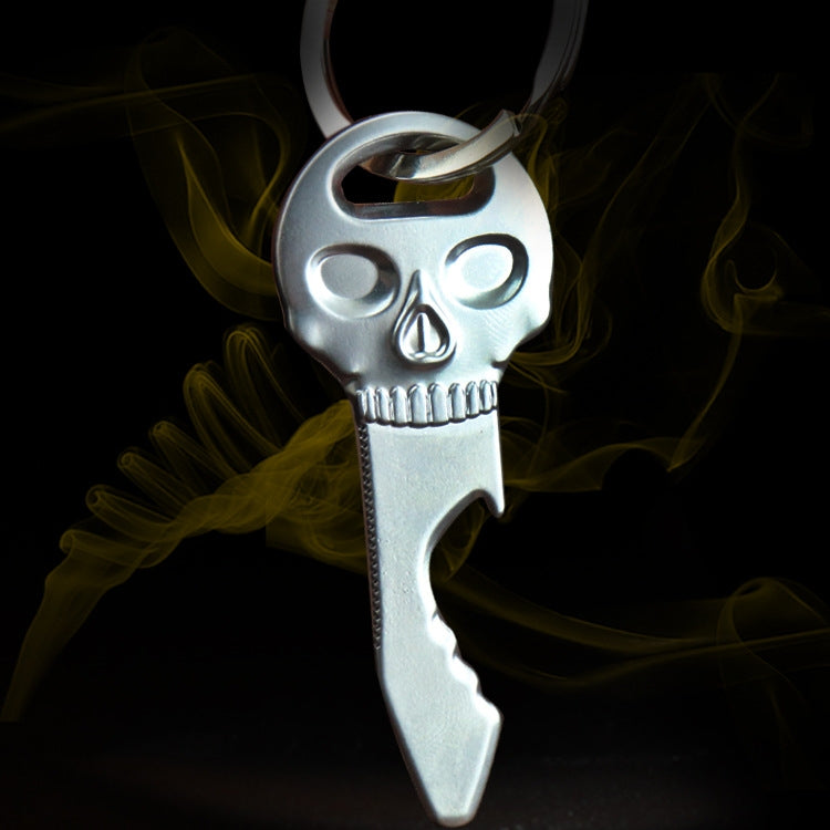 Silver skull-shaped bottle opener key chain with loop key ring and flame detail