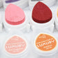Close-up of pink and red droplet-shaped ink stamp pads with round color lids