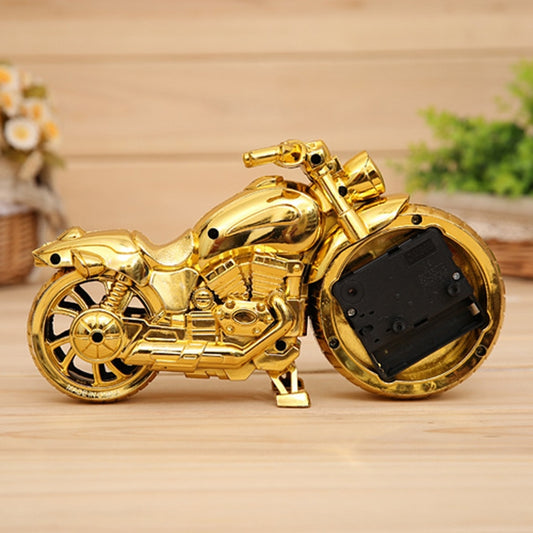Gold motorcycle alarm clock back view with black battery panel and front wheel