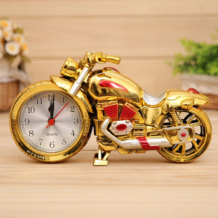 Gold cartoon motorcycle alarm clock with red accents, round pointer dial, and red alarm hands