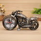 Black and silver cartoon motorcycle alarm clock on wheels with pointer dial and red minute hand