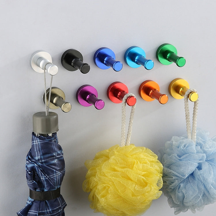 Round single wall hooks holding bath accessories, with colored posts and bases.