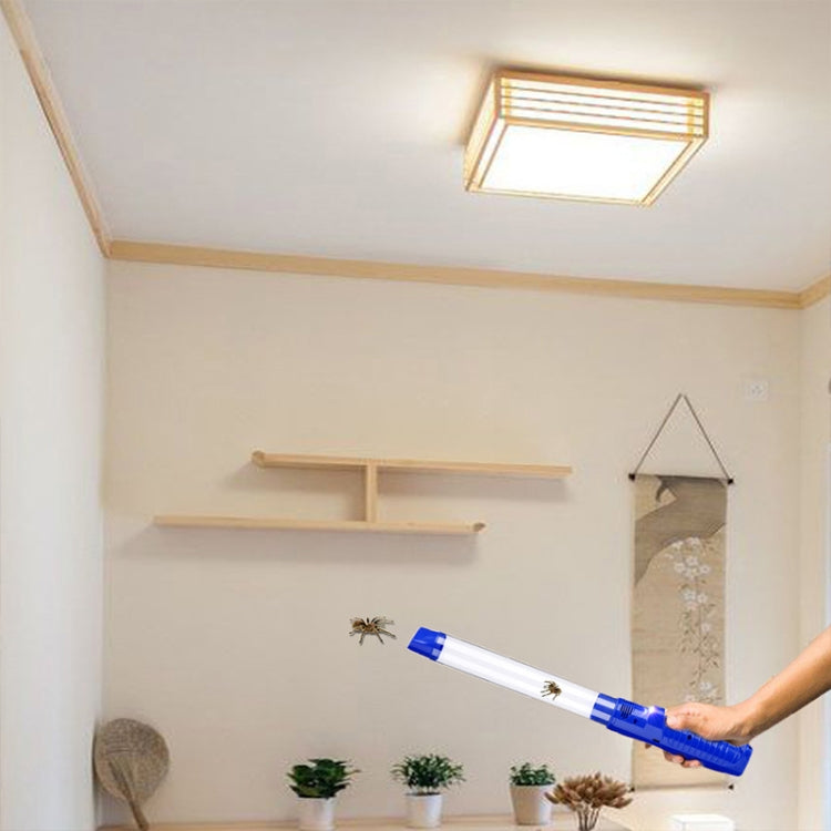 Blue and white handheld insect suction trap catcher with long tube, indoors