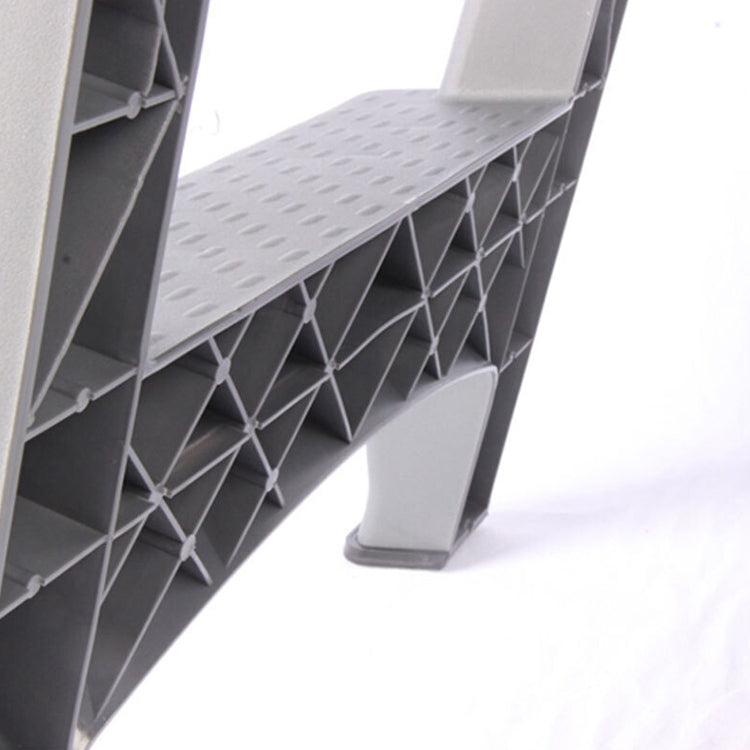 Close-up of gray ladder steps and support frame with cross-bracing