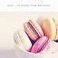 Macaron silicone baking pad with macarons, white liner beneath pastries
