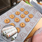 Macaron silicone baking pad on tray with cookies, white with orange and gray pattern