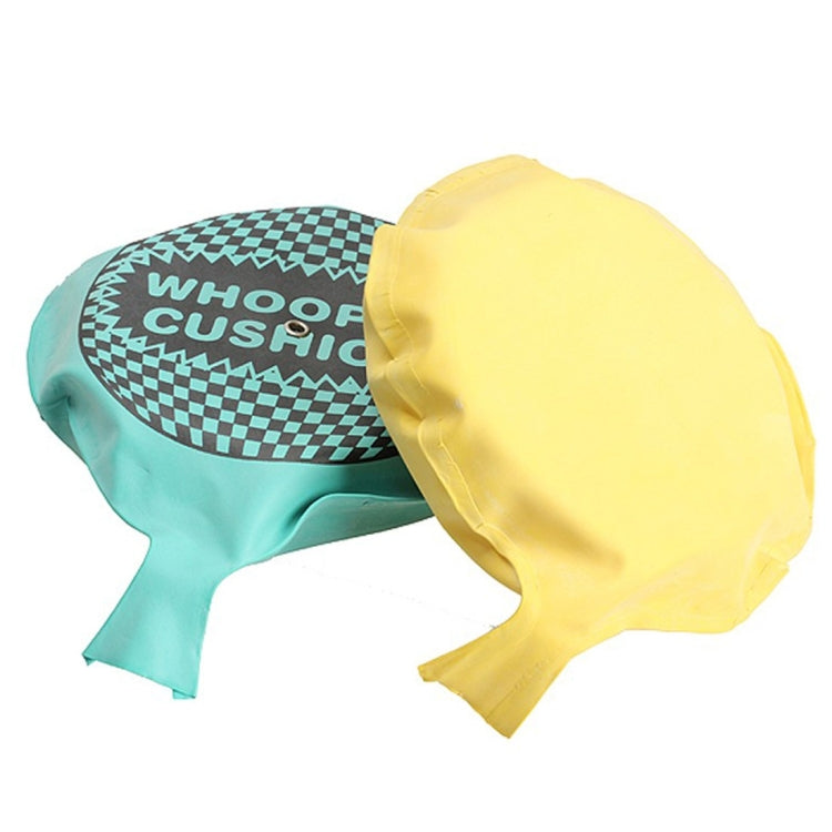 Teal and yellow whoopee cushion gag toys with checkered logos and “WHOOP CUSHION” text.