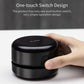 Black mini desktop cleaner with one-touch button, hand pressing the front control