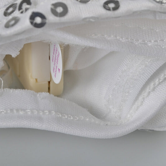 Close-up of white glove wrist seam and fabric with sequin trim