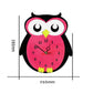 Owl-shaped wall clock, pink and black with yellow beak; shows overall size dimensions