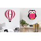 Owl-shaped pink and black wall clock on a wall above a console table with decor