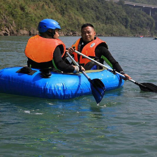 Adult orange life jacket with black straps, worn on a blue raft during paddling