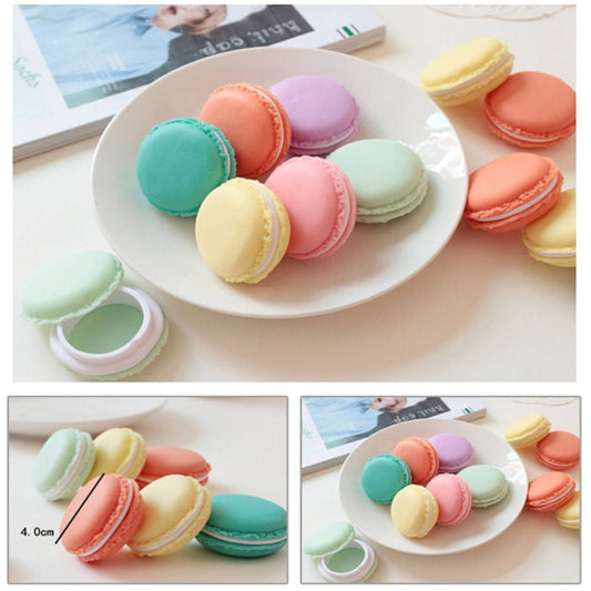 Macaron-style medicine boxes in assorted pastel colors on a white plate