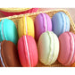 Macaron-style storage boxes in a wicker tray, assorted pastel colors