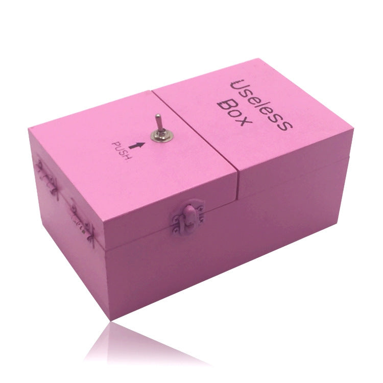 Pink wooden useless box with engraved "Useless Box" and push knob on lid