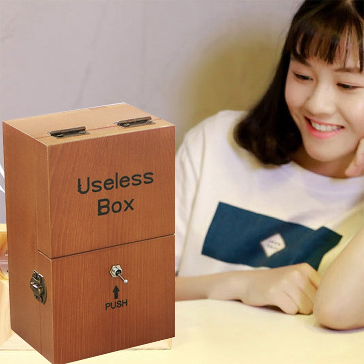 Wooden useless box with "Useless Box" engraving and push-button front panel