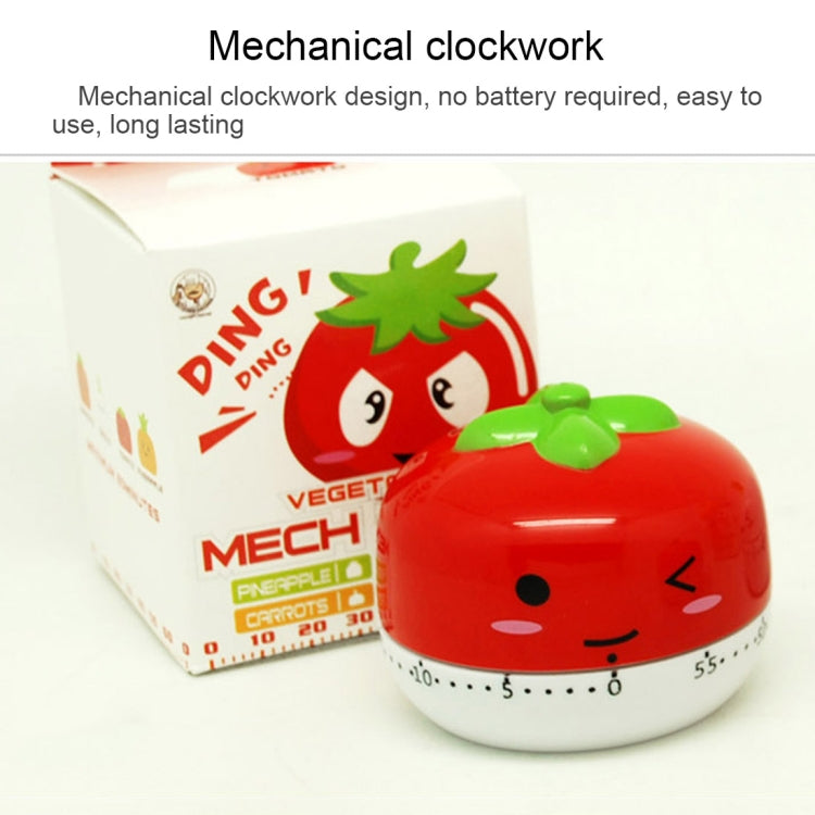 Red tomato-shaped mechanical kitchen timer with cartoon face and time dial