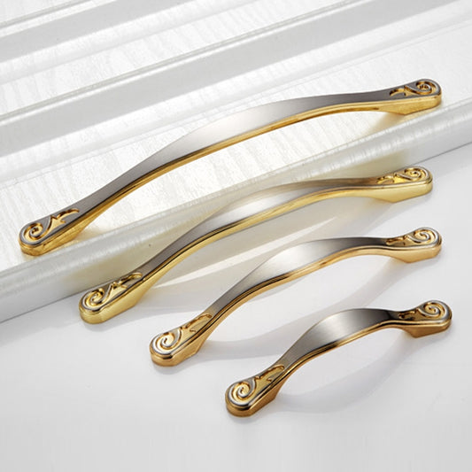 Set of three double-arched cabinet handles in gold with decorative scroll ends