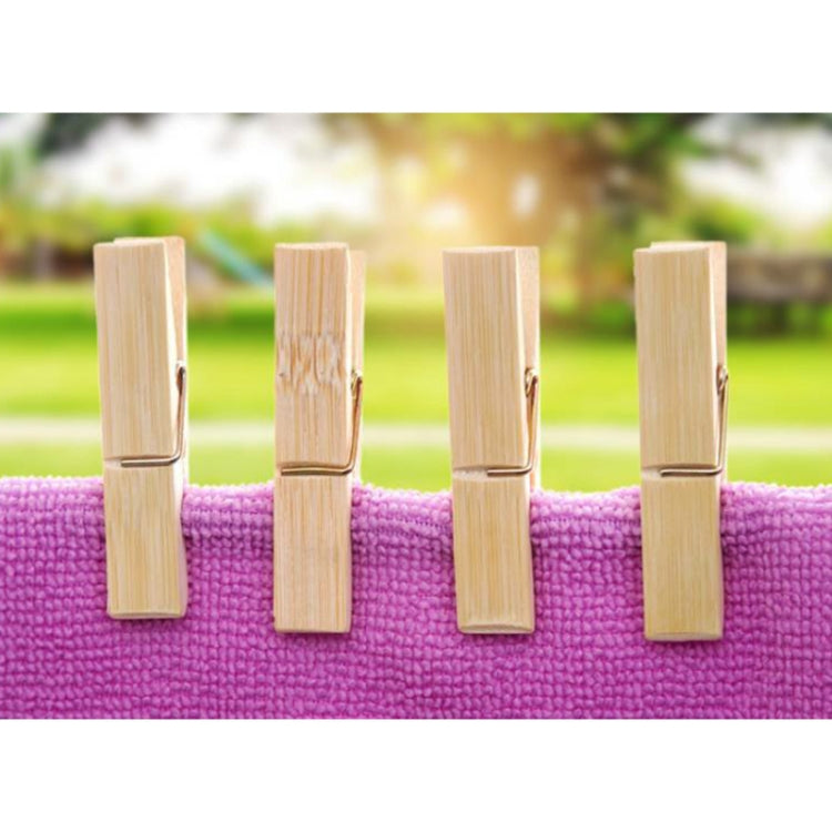 Set of four light bamboo clothespin clips on a purple fabric strip
