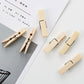 Bamboo peg clips arranged near paperwork, showing metal spring and wooden body