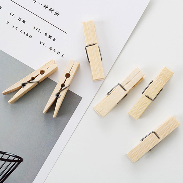 Bamboo peg clips arranged near paperwork, showing metal spring and wooden body