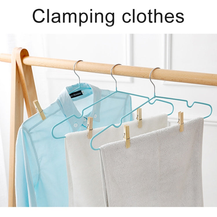 Bamboo clothespin peg clips clamping laundry on a hanger bar