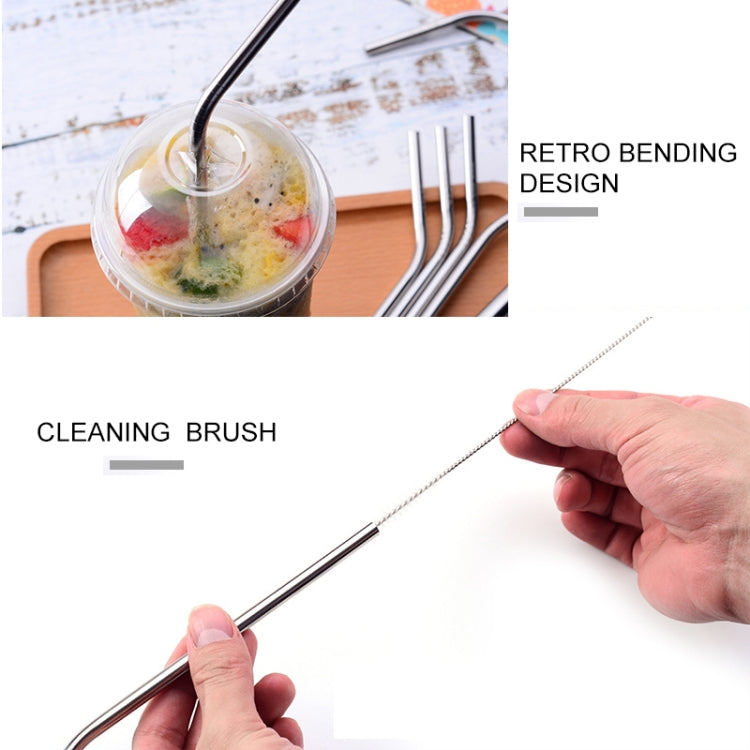 Hand holding cleaning brush to clean a reusable stainless steel drinking straw