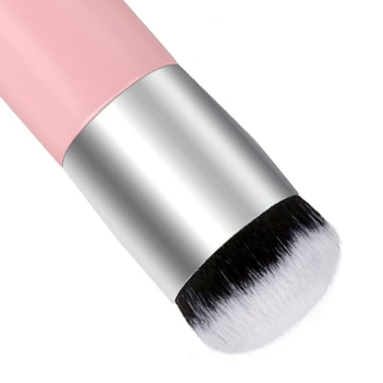 Large round makeup brush head detail with pink handle and dense soft bristles