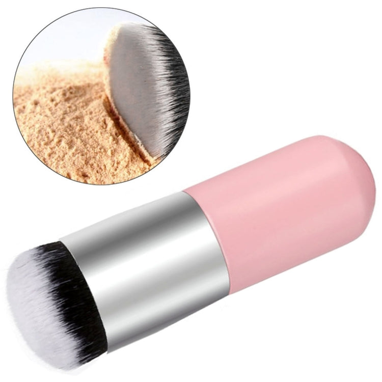 Large round makeup brush with pink handle; inset shows powder on bristles