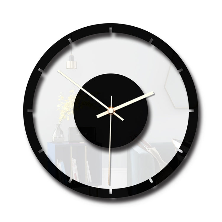 Round wall clock with black rim, clear acrylic face, black center disc, gold hands