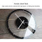 Round wall clock with clear acrylic face, black rim, black center disc, gold hands