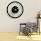 Round wall clock with black rim, clear acrylic face, black center disc, gold hands